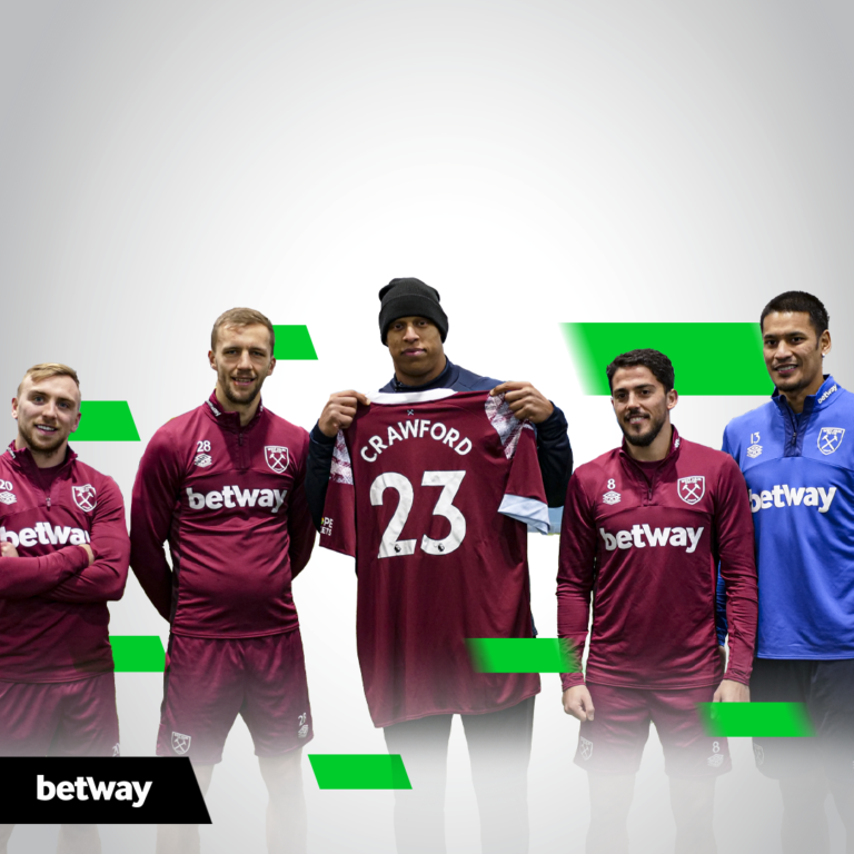 Five soccer players don West Ham United training attire, with one in a blue jersey showcasing a maroon CRAWFORD 23 jersey. The background features gray and green geometric accents, highlighting the betway arabia logo at the bottom left.